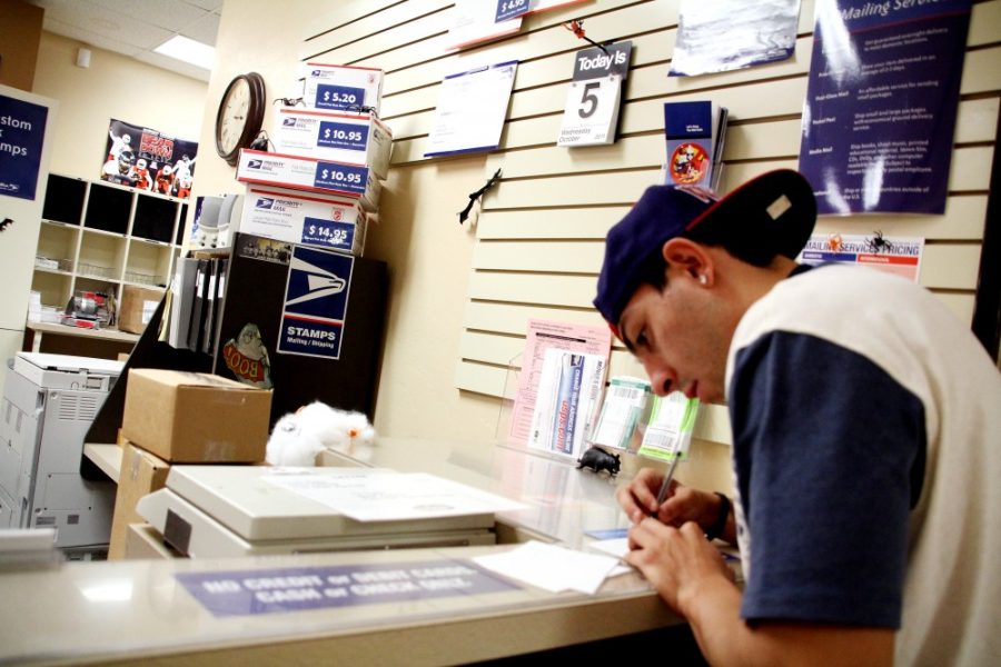 Kevin Brost  / Arizona Daily WIldcat

Freshman Ryan Katz prepares a piece of mail before sending it out at the Student Union Post Office on October 5, 2011.
