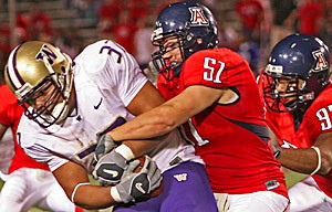 UA linebacker Spencer Larsen tackles Johnie Kirton in Arizonas 21-10 loss to Washington last week at Arizona Stadium. Larsen and the Wildcats hope to play with more consistency than they did last week in tomorrows 4 p.m. game at UCLA, which will be televised nationally on FSN.