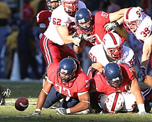 Arizona and Stanford football players watch the football tumble away during the Wildcats 21-20 loss to the Cardinal on Oct. 20 at Arizona Stadium. The Wildcats will need to make some adjustments to win the final three games of the season. 