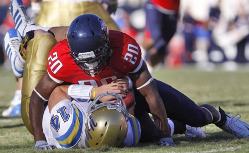 Senior safety Cam Nelson tackles UCLA freshman quarterback Kevin Prince to the ground on Saturday as Arizona defeated the Bruins 27-13. Nelson has evolved to be a key part of Arizona?s defense this season. 