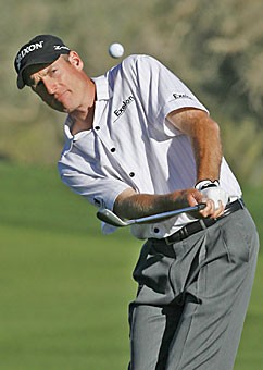Jim Furyk pitches his third shot on the 19th hole, where his par did not match opponent Chad Campbells birdie in Campbells 1-up victory in the second round of the World Golf Championships Accenture Match Play Championship in Marana on Feb. 22.