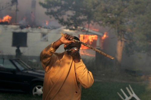 A man runs away from a fire on Detroit, Michigan's east side, Tuesday, September 7, 2010. Fires raging across large sections of the city tonight are being blamed on downed electrical wires. (Marcin Szczepanski/Detroit Free Press/MCT)