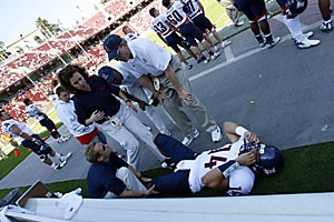 Senior quarterback Adam Austin is examined by members of the Arizona training staff after injuring his left knee in the second quarter against Stanford on Oct. 14. Austin returned to practice last night and may play Saturday against Washington State. 