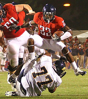 Arizona running back Nick Grigsby avoids the tackle during the Wildcats 45-24 victory over NAU last year.