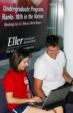 Financing junior Callan Smith, left, and marketing senior Rick Potter collaborate together on a marketing project Thursday in the foyer of McClelland Hall.
