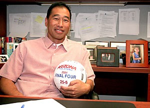 Volleyball head coach Dave Rubio grasps his 2001 Final Four commemorative ball yesterday at his office in McKale Center. Since Rubio took over, he has guided Arizona to a 287-144 record (.666 winning percentage). 