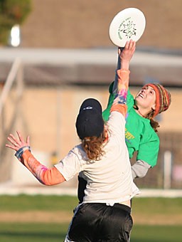 Caitlin Wright, a sophomore majoring in interdisciplinary studies and international relations, and Julie Roo Husid, a senior majoring in geography and communications, front, fight over the Frisbee during practice Jan. 22 at Rincon Vista Fields. The two are members of the Arizona womens Ultimate Frisbee club team.