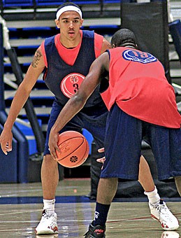 Guard Nic Wise, right, pauses outside the 3-point line as forward Marcus Williams waits in anticipation during Saturdays scrimmage. The blue team took the first half, 67-33, before the teams were reshuffled and the red team won the second, 