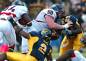 Center Blake Kerley (50) bridges the gap for UA wide receiver Terrell Turner in Arizonas 45-27 loss against California in Berkeley, Calif., on Saturday. Kerley and the rest of the offensive line are still acclimating to a pass-heavy offense but are on pace to have 10 fewer sacks than last season. 