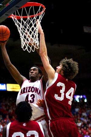 Arizona forward Jordan Hill, left, works his way past WSU forward Robbie Cowgill in the Wildcats 72-66 loss to Washington State in McKale Center on Feb. 1, 2007. The Wildcats beat the Cougars 41 out of 42 times before suffering a series sweep at the hands of WSU last season.