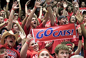 Fans cheer from the student section during last Marchs 70-67 loss to Washington in McKale Center. Arizonas student government has created a group of yell leaders to organize chants and line up in front of the opponents team bus.