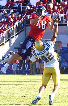 UA tight end Rob Gronkowski rises for a catch while trying to evade the hands of UCLA 