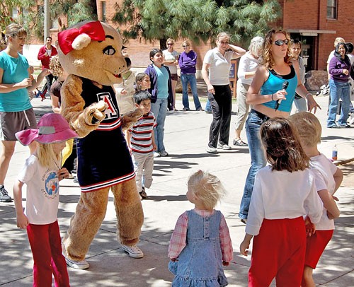 Students and families learn salsa dancing with Wilma Wildcat at the Southern Arizona Language Fair on Saturday. The fair was sponsored by the College of Humanities and featured crafts, shows, food and dancing for children from Tucson schools.