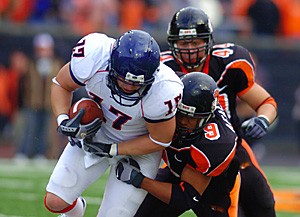 Arizona tight end Brad Wood (17) gets pulled down by Oregon States Al Afalava (9) during the first half of Arizonas 29-27 win over Oregon State, Saturday Oct. 29, 2005 at Reser Stadium in Corvallis, Ore. The win was Arizonas first Pac-10 conference win this season(Photo by Chris Coduto/Arizona Daily Wildcat)