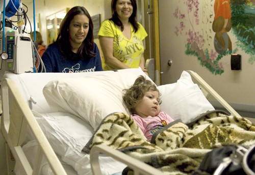Tim Glass / Arizona Daily Wildcat 

Nurses wheel Isabella Alvarez, two years old, with her mother, Sandi Alvarez close behind, from the third floor of University Medical Center to the new fifth floor Diamond Childrens Center early Tuesday morning, April 27, 2010.  Hospital staff also used the move to practice evacuation procedures.