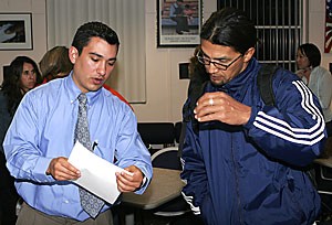 Jacob Cortes, left, of the Pima County Interfaith Council discusses the possible effects of Proposition 300 with Jose Gonzalez, a teacher at Tucson High School and Rincon High School. There was a roundtable discussion with community members and organization leaders last night at the C