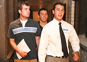 Pre-business sophomore Josh Mendell, right, gives biology freshman Michael Arce and computer science freshman Devin Stevens, left, a tour of the Sigma Alpha Epsilon house yesterday. The new fraternity rush procedures no longer require students to visit every fraternity house on campus, but students who do will be entered in a drawing to win an Apple iPod. 