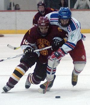Icecats forward Jordan Schupan battles for the puck with ASUs Joe Ahern in the Tucson Convention Center on Dec. 7. Schupan also scored a goal in the Icecats 3-0 win.