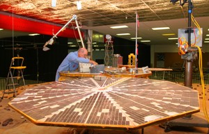 Rick McCloskey, the Payload Interoperability Testbed manager works on the Thermal and Evolved Gas Analyzer on the engineering model of the Phoenix Lander. The TEGA will allow scientists to analyze the soil collected from Mars surface.