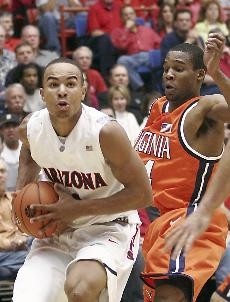 UA guard Jerryd Bayless works around Virginia guard Sean Singletary in Arizonas 75-72 loss to the Cavaliers Saturday night in McKale Center. Singletary led all scorers with 24 points, while Bayless posted a team-high 21.