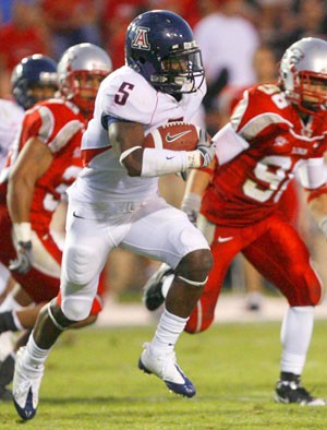 Arizona sophomore running back Nic Grigsby carries the ball in Arizonas 36-28 loss to New Mexico Saturday at University Stadium in Albuquerque. Though the Wildcats run the spread offense, the running game is a very integral part of Arizonas success. 