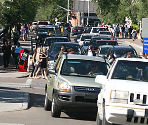 Looking north at the intersection of Mountain Avenue and Second Street, traffic builds as students cross the street.