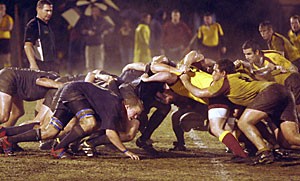 Members of the Arizona mens club rugby team (left) find themselves in a scrum with ASU on Friday night at the Rincon Vista Complex. The Wildcats faltered in the muddy and wet conditions, losing 15-3.