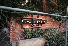 The Sigma Phi Epsilon fraternity house is surrounded by a fence after the chapter was shut down. 