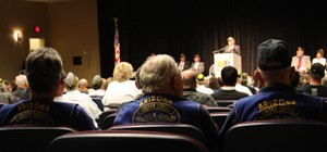 Retired members of the United States Navy listen to fellow Navy retired servicemen speak on Sunday in the Gallagher Theater during a memorial ceremony commemorating the anniversary of the Pearl Harbor attacks and subsequent sinking of the USS Arizona.