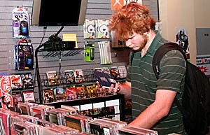 Business freshman David Olson searches for a new album at Replay Entertainment in the Student Union Memorial Center. The store may be relocated to the bottom level of the bookstore at the Union because of low sales.