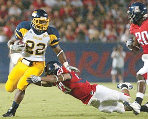 Arizona cornerback Marquis Hundley lunges after Toledo running back DaJuane Collins during the Wildcats 41-16 win at Arizona Stadium Sept. 6. Hundley is one of four junior college transfers making a significant contribution to Arizonas defense, which is ranked second in the country in total defense.