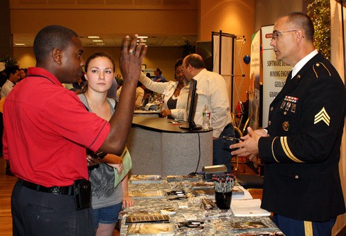 Rodney Haas / Arizona Daily Wildcat

Alexis Higbee, a junior majoring in Spanish, center, speaks with U.S Army Sgt. Jeff Dozier, right, and UA Army ROTC Major Vernal Fulton about joining the Army during the UA Career Fair held in the Student Union Memorial Center yesterday. The fair, which goes on today from 11 AM to 4 PM, is a place for employers from all over the country come to the fair to talk to students about their company and how they hire.
 