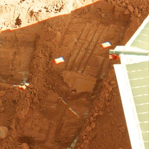 This photo released by NASA shows the edge of a solar panel on NASAs Phoenix Mars Lander, right, in a trench on the surface of Mars, where a sample of soil was taken by the lander. NASA announced Sept. 29 that the spacecraft discovered two minerals in the Martian soil that suggest interaction with water in the past.