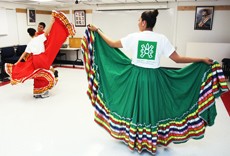 Photo Illustration by Mike Christy / Arizona Daily Wildcat

Raquel Verdugo, right, a criminal justice freshman and student office worker with the Chicano/Hispano Student Affairs, displays her performance dress on Thursday in the Cesar E. Chavez building. In the background, Isela Hernandez, a nursing junior, and Ismael Peraza practice their cultural dancing audition for the April 9th ONELOVE Multicultural Showcase at the UA.
