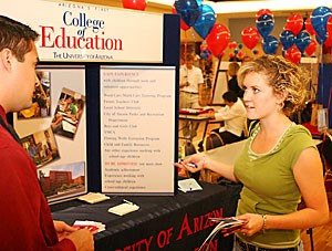 Pre-nursing freshman Chelsea Woodall discusses majors with Albert Muniz, a recruitment and retention adviser for the College of Education, yesterday at the Meet Your Major Fair in the Student Union Memorial Center.