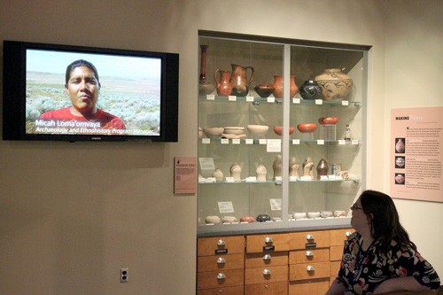 Lisa Beth Earle/ Arizona Daily Wildcat

Mackenzie Massman, Head of Operations at the Arizona State Museum, watches an excerpt from a video about various Hopi artists and traditions in the museums Pottery Project Gallery. Micah Lomaomvaya, pictured on the screen, is a Hopi tribal member who will lecture on Hopi running traditions in the Gallery on Jan. 20.