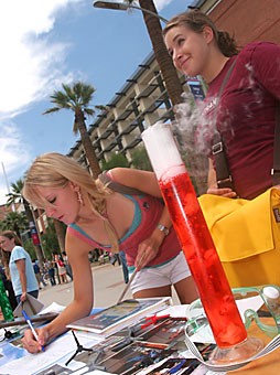Biology freshman Megan Hamre shows interest in the Chemistry Club on the UA Mall yesterday, as studio art freshman Adrienne Lobl looks on.  Over 200 UA clubs displayed booths to gain membership for nearly 5 hours yesterday. 