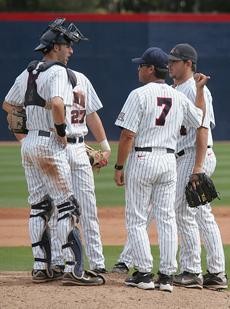 UA head coach Andy Lopez (7) meets with players on the mound during a 9-0 Arizona win against UMass on March 8 at Sancet Stadium. The Wildcats have struggled to a 3-12 record in Pacific 10 Conference play in large part because of poor performances by young pitchers.