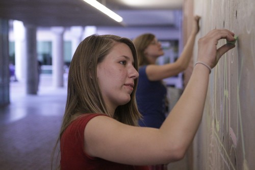 Timothy Galaz / Arizona Daily Wildcat
Students get Flu Shots in front of the Chalk drawings in the ILC and around campus express students feelings. 