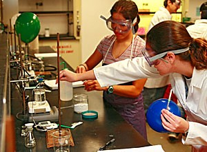 Chemistry teaching assistant Diana Cedeno, left, delivers the catalyst for biochemistry freshman Joy Meserves hydrogentation lab yesterday in the Koffler building. The National Science Foundation has given the UA a $3.3 million grant to increase womens presence in science, which will benefit research like that of Cedeno and Meserve.