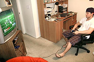 Former UA backup kicker Adam Goldstein, a finance senior, plays NCAA Football 2007 on Playstation 2 as Arizona last night in his bedroom. After being a member of the football team for the past three years, Goldstein left the squad to concentrate on his future career in finance.