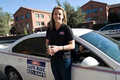 ASUA senator Lindsay Hartgraves, a pre-education and English sophomore, stands by a safe ride car on Tuesday, Feb. 8, 2011.  Hartgraves rode in safe ride cars on Monday night to better connect with the student population.