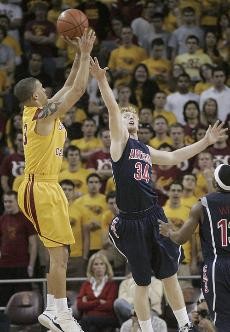USC guard Daniel Hacket shoots over UA forward Chase Budinger in Saturday nights 65-64 Trojan win at the Galen Center. Hacket made the game-winning shot at the free-throw line after he was fouled by Jamelle Horne with 1.3 seconds left. 