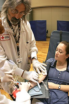 Pre-business sophomore Elyse Birnbaum donates blood at the Graduate and Professional Student Council blood drive yesterday in the Grand Ballroom of the Student Union Memorial Center. The drive continues today beginning at 8 a.m. and ending at 4 p.m.