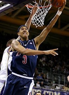 Arizona forward Marcus Williams goes up for a shot over Washington center Spencer Hawes during the second half of the No. 7 Wildcats 96-87 win at No. 24 Washington Thursday. Williams scored 22 points in his return to his hometown of Seattle, including eight straight for Arizona at one point.