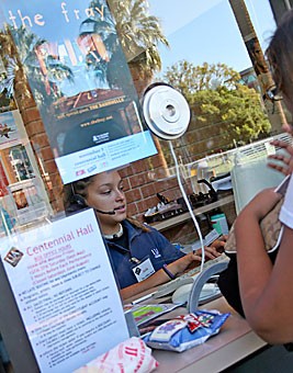 Sasha Ellington, a junior majoring in philosophy and Spanish, sells tickets to the upcoming The Fray concert to molecular and cellular biology freshman Aneesha Hossain yesterday afternoon. Hundreds of students lined up to buy tickets yesterday morning, and some even camped overnight to be among the first in line.