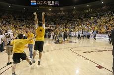 ASU fans storm the court after a 70-68 Sun Devil win against Arizona on Feb. 22 at Wells Fargo Arena in Tempe. ASU beat the Wildcats three times during the 2008-09 season.