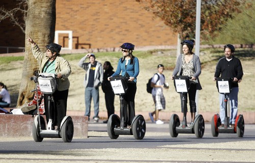Alan Walsh / Arizona Daily Wildcat

Denise Russell, left, partner-owner of Roll With It! segway tours, points out the cactus gardens on the UA mall to a group of tourists as they trek across campus yesterday afternoon.