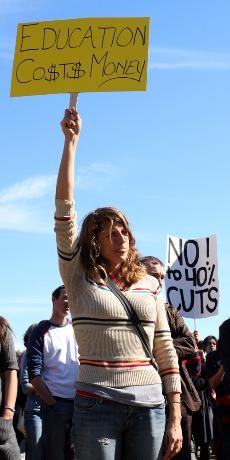 Jessica McGary, a political science graduate student stands in front of the crowd of protesters on the UA mall Tuesday afternoon. 