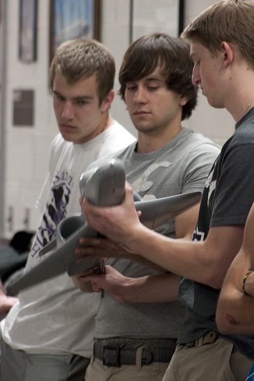 Janice Biancavilla / Arizona Daily Wildcat

 (Left to right) Kevin Lohmeier, Casey Odom, and Michael Ross examine a model airplane near the wind tunnel in the Aerospace and Mechanical Engineering building.   Highschool students from Sabino Canyon High School who are enrolled in Engineering 102 as students in the science technology, engineering and mathematics, or STEM initiative, toured the building Tuesday. 
